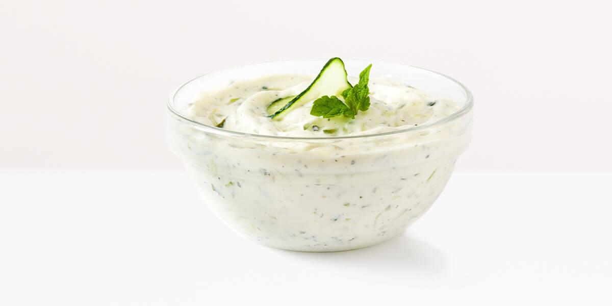 Tzatziki, grocery store produce, on a blank background.