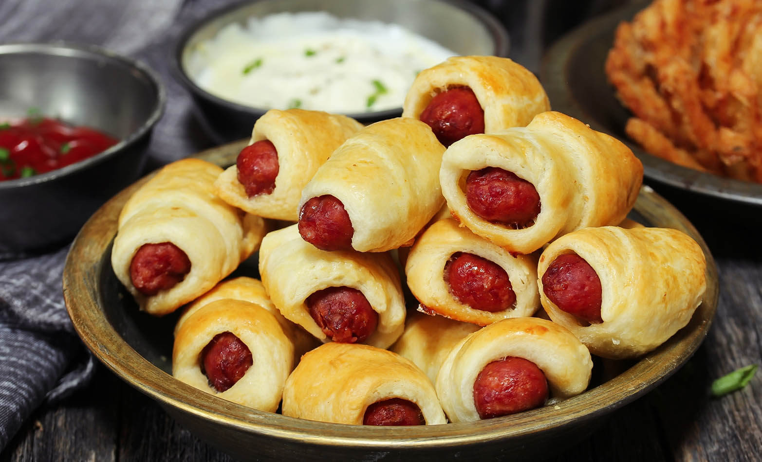 a serving platter of pigs in a blanket