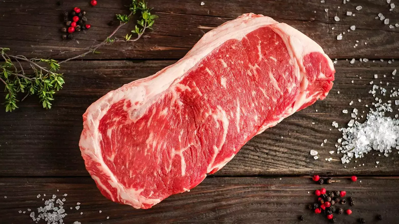 raw new york strip ready to be seasoned