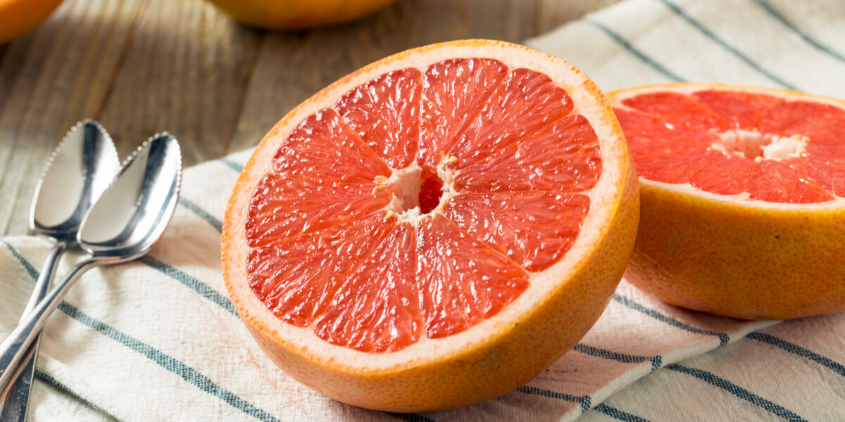 Grapefruit cut in half sitting on a table.