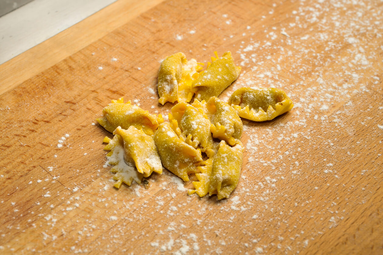 agnolotti del plin on wooden cutting board