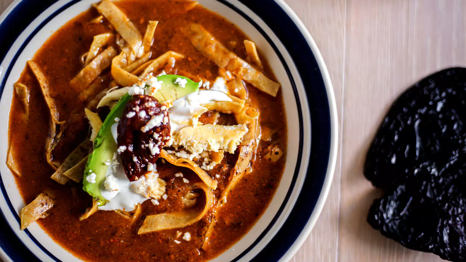A bowl of vegetarian tortilla soup.