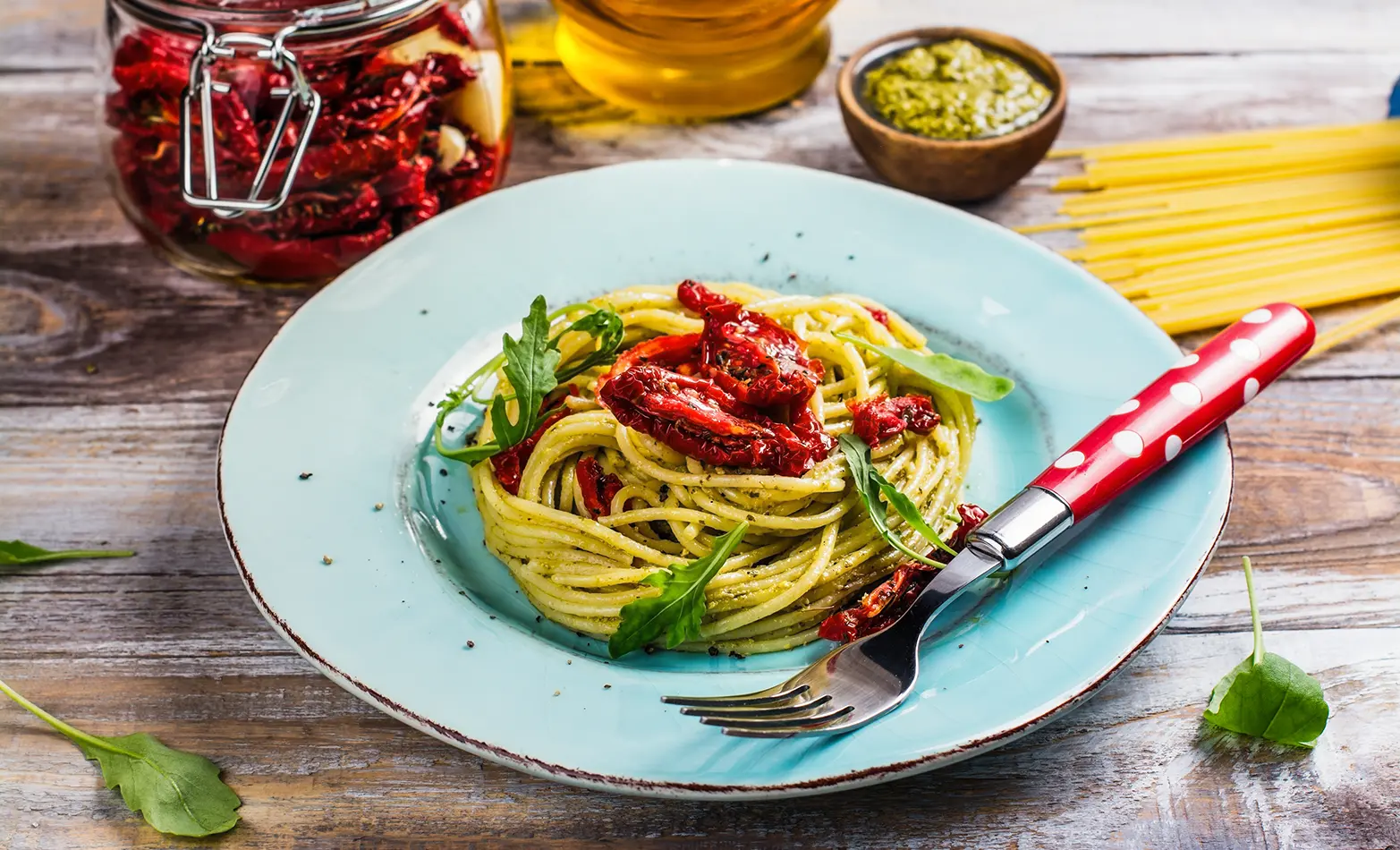 A plate of arugula pesto pasta