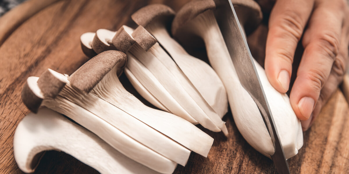 Sliced mushrooms on a cutting board.