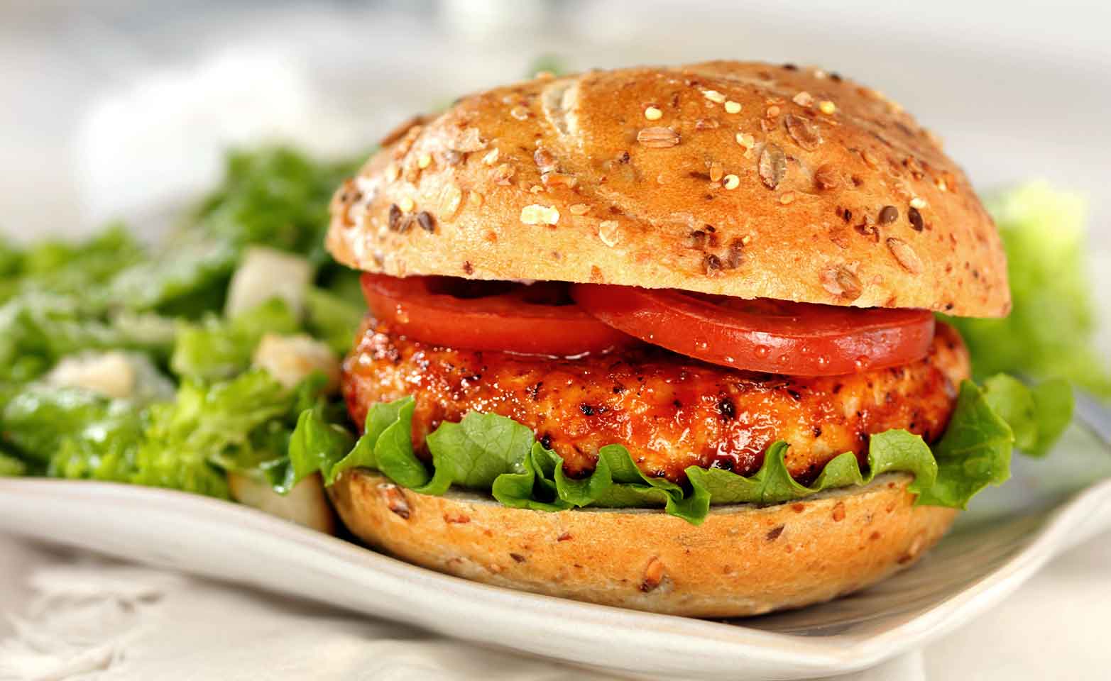 Stock image of turkey burgers with tomatoes and lettuce