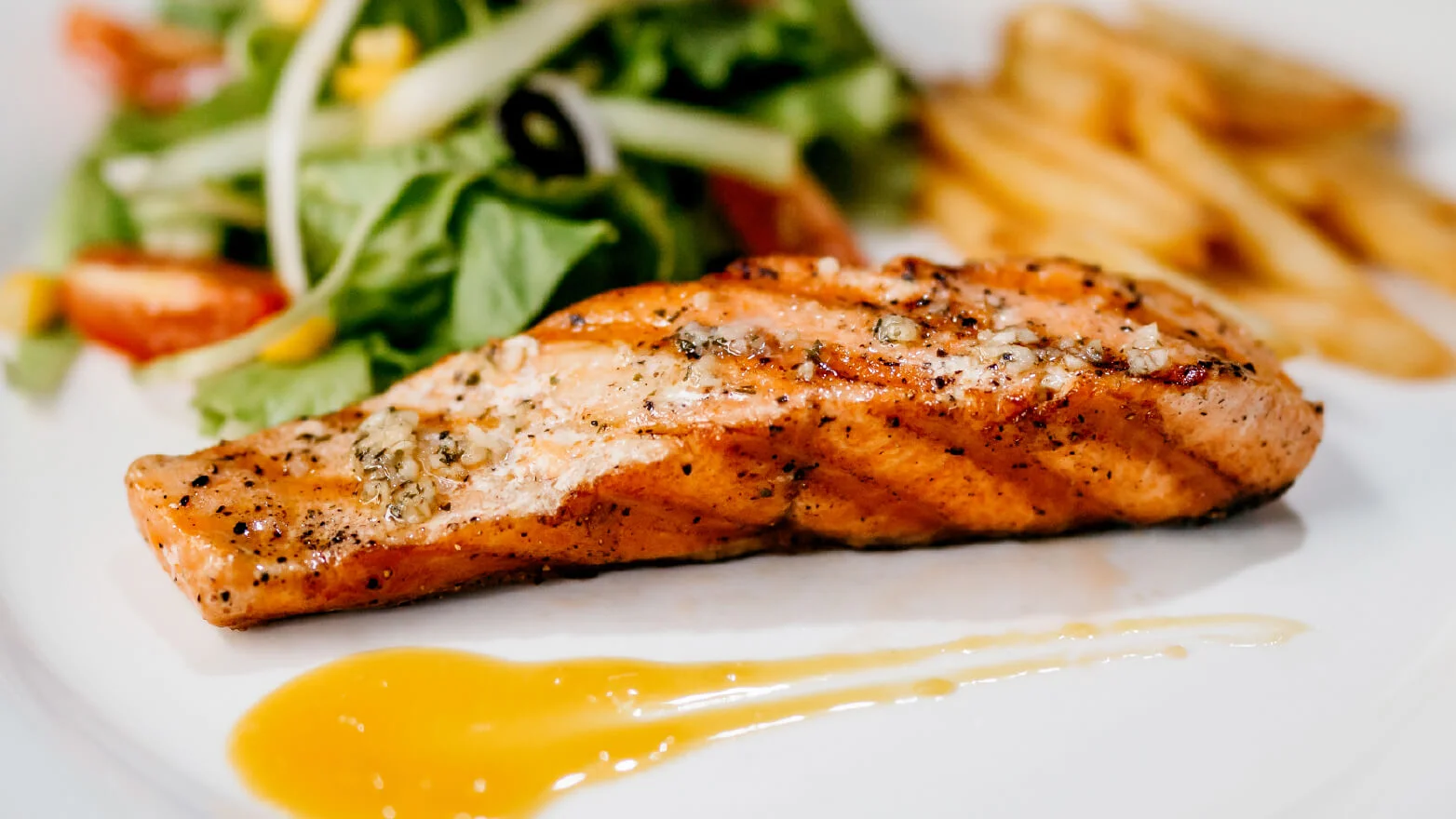 a photo of grilled salmon with lemon garlic sauce
