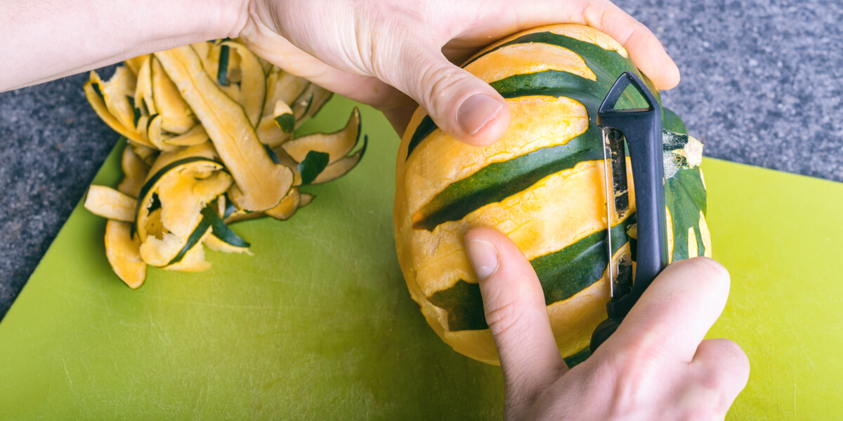Peeling an acorn squash.