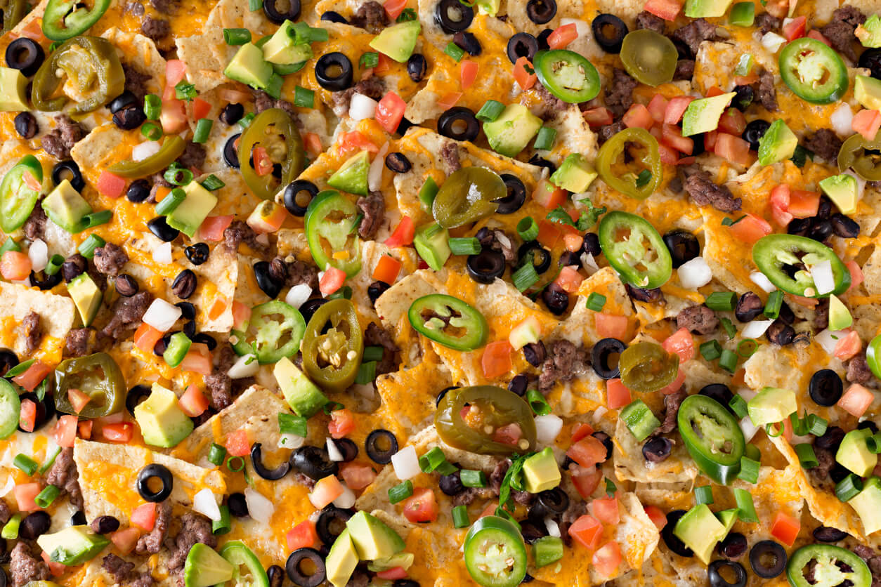 An overhead close up horizontal photograph of some spicy nachos.