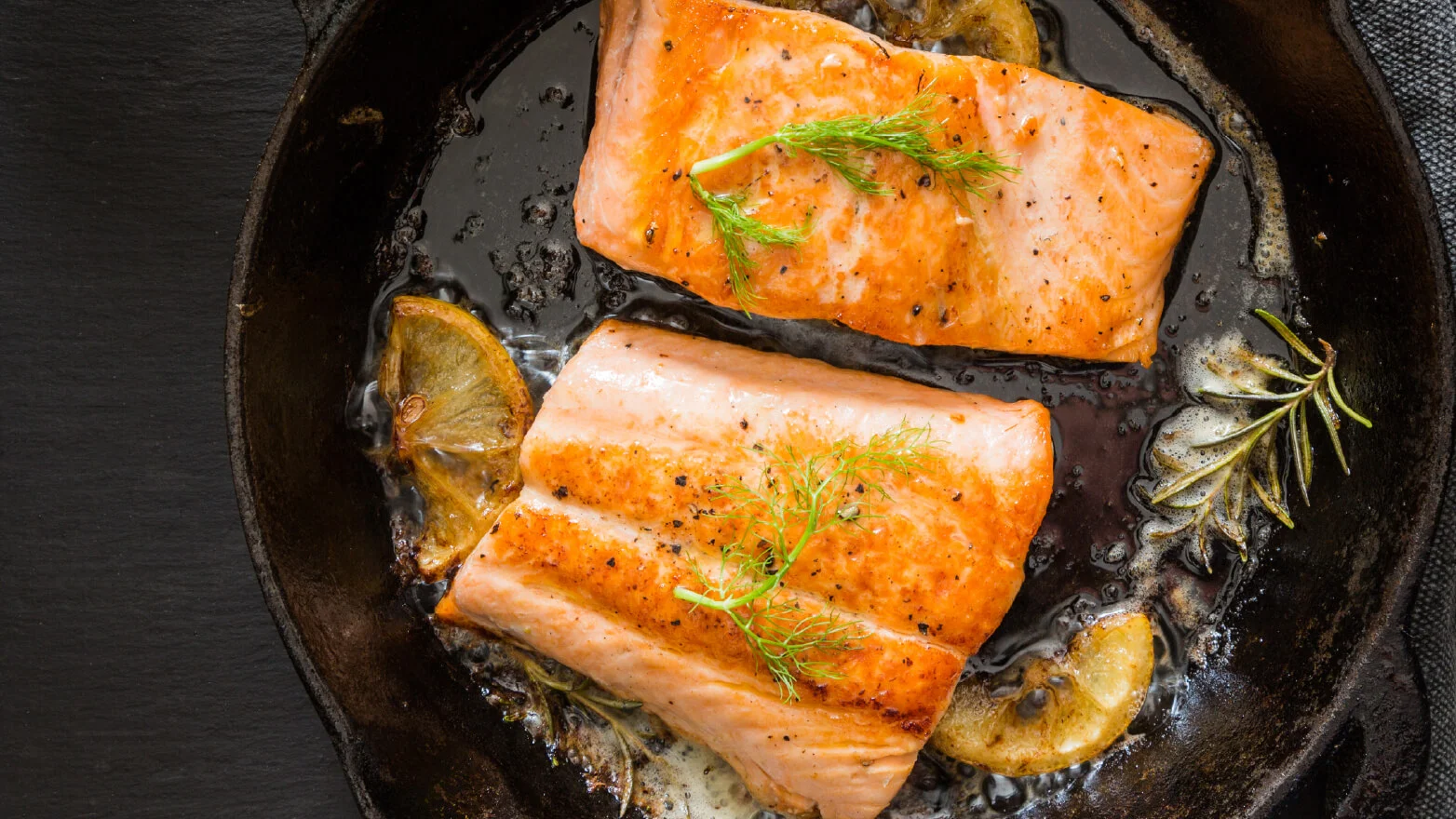 a photo of cast iron salmon with lemon herb butter