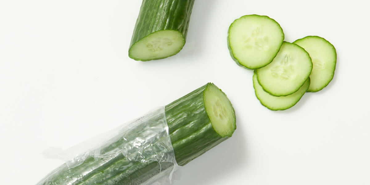 English cucumbers, grocery store produce, on a blank background.