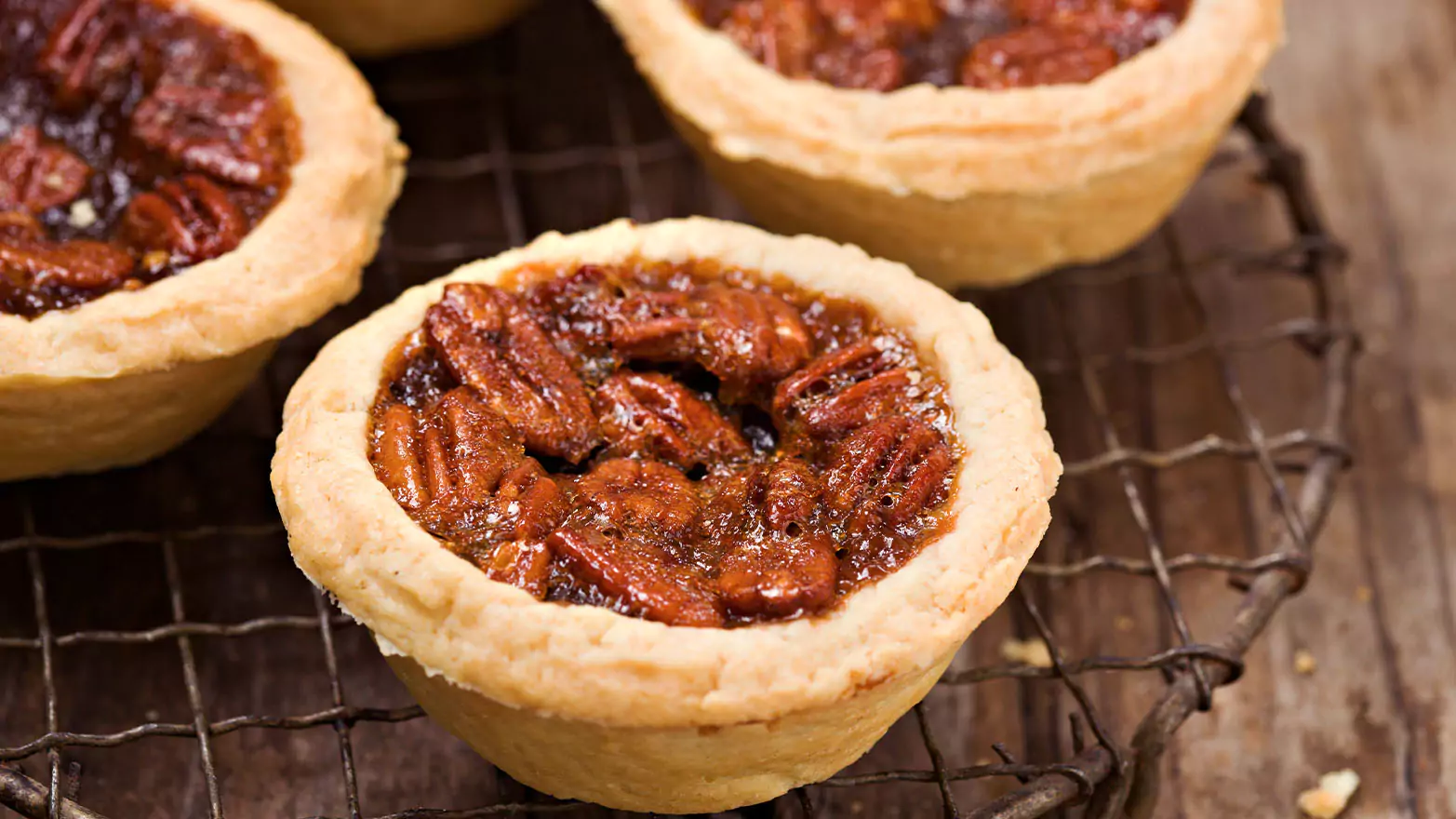 Mini pecan pies on a cooling rack