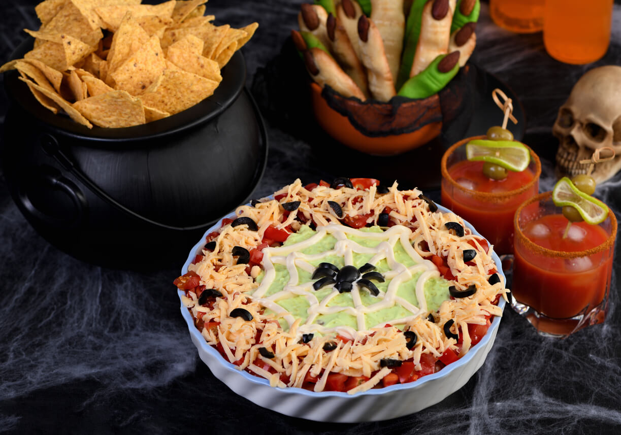 Spooky Halloween Seven Layer Taco Dip: Turn a classic appetizer into a Halloween with of black olive spider .