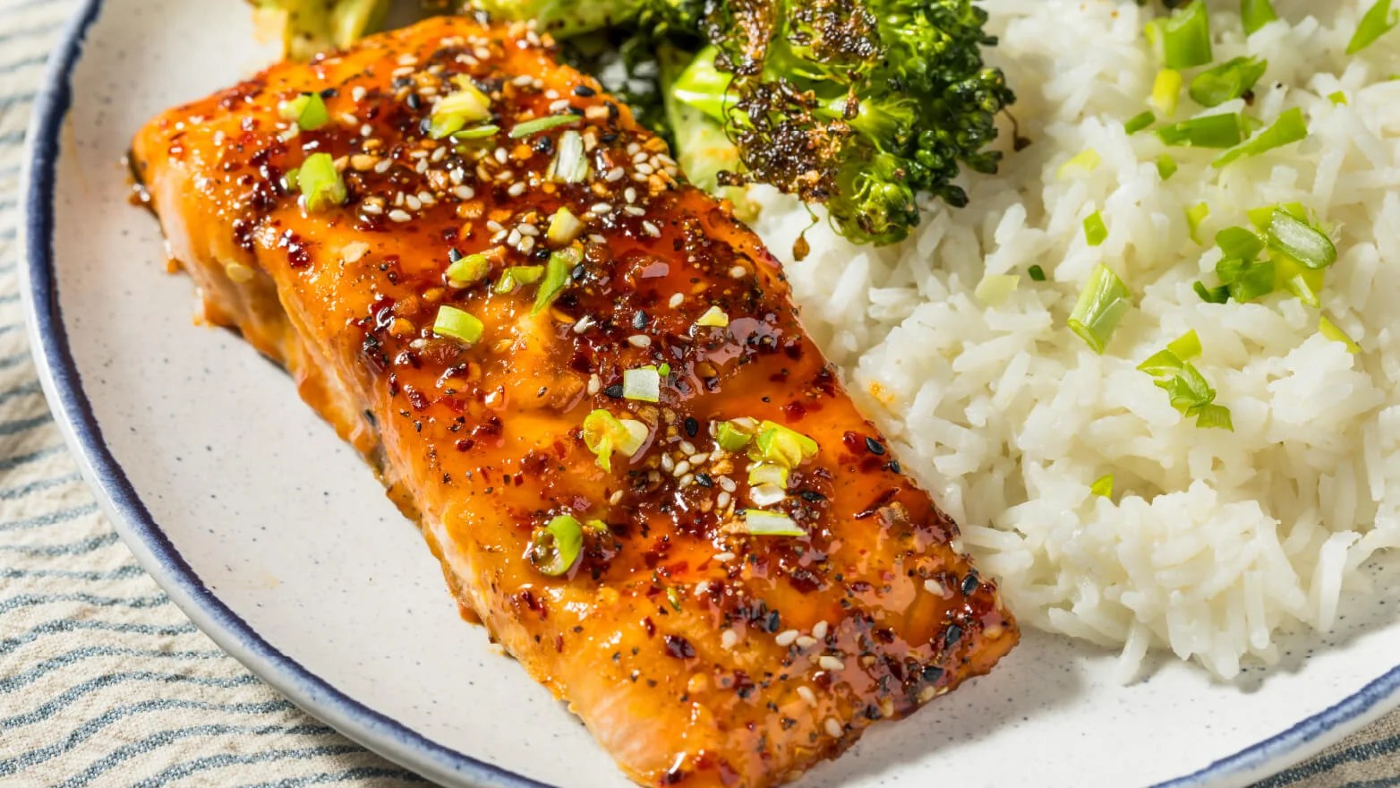 a photo of honey baked salmon served with rice