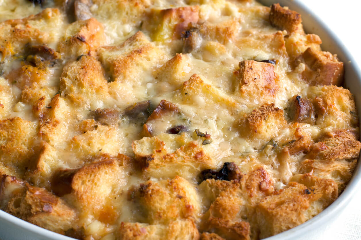 Closeup of golden melted cheese and savory bread pudding.