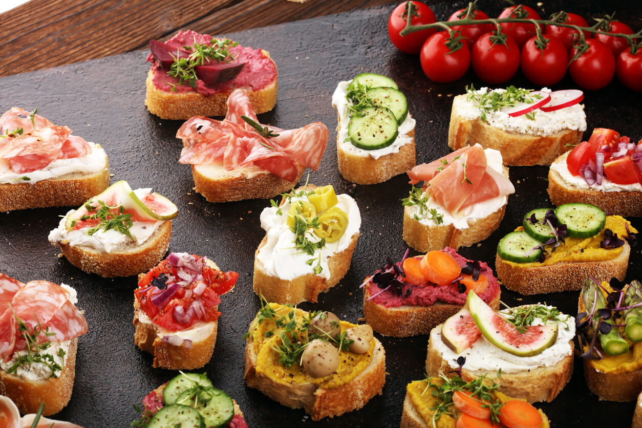 Assorted bruschetta with various toppings.