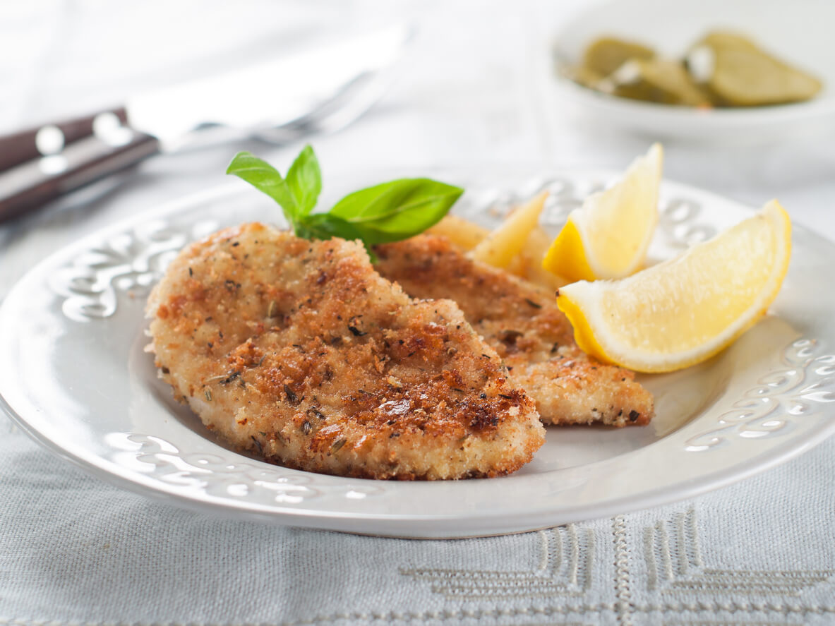 Chicken or pork schnitzel with lemon wedges, selective focus
