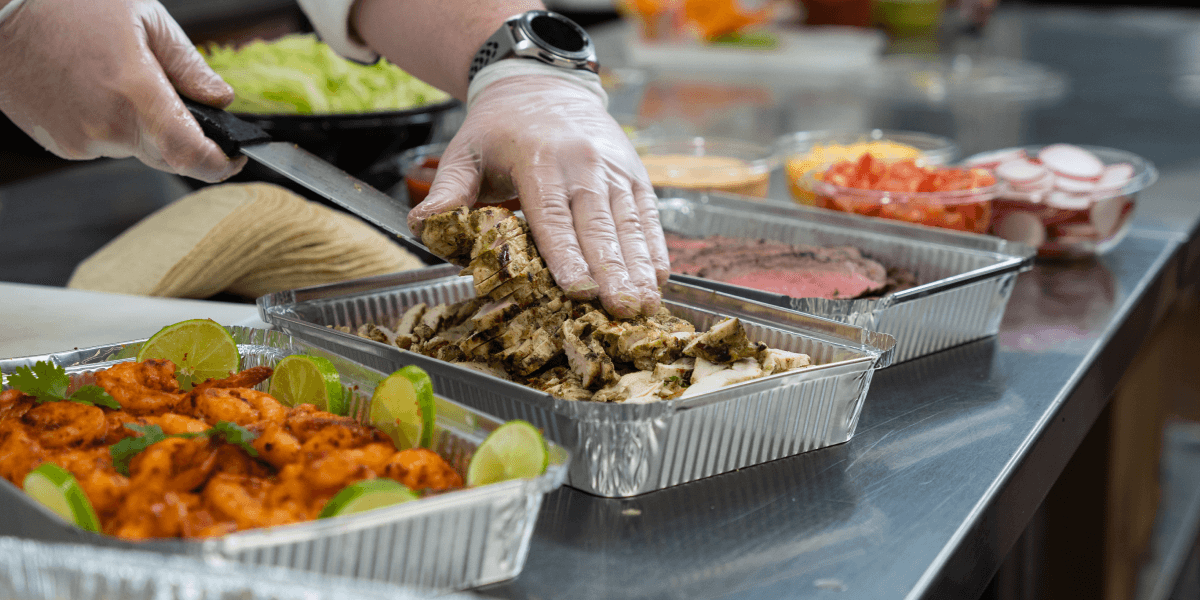 Image of catering manager preparing multiple dishes for holiday food catering 
