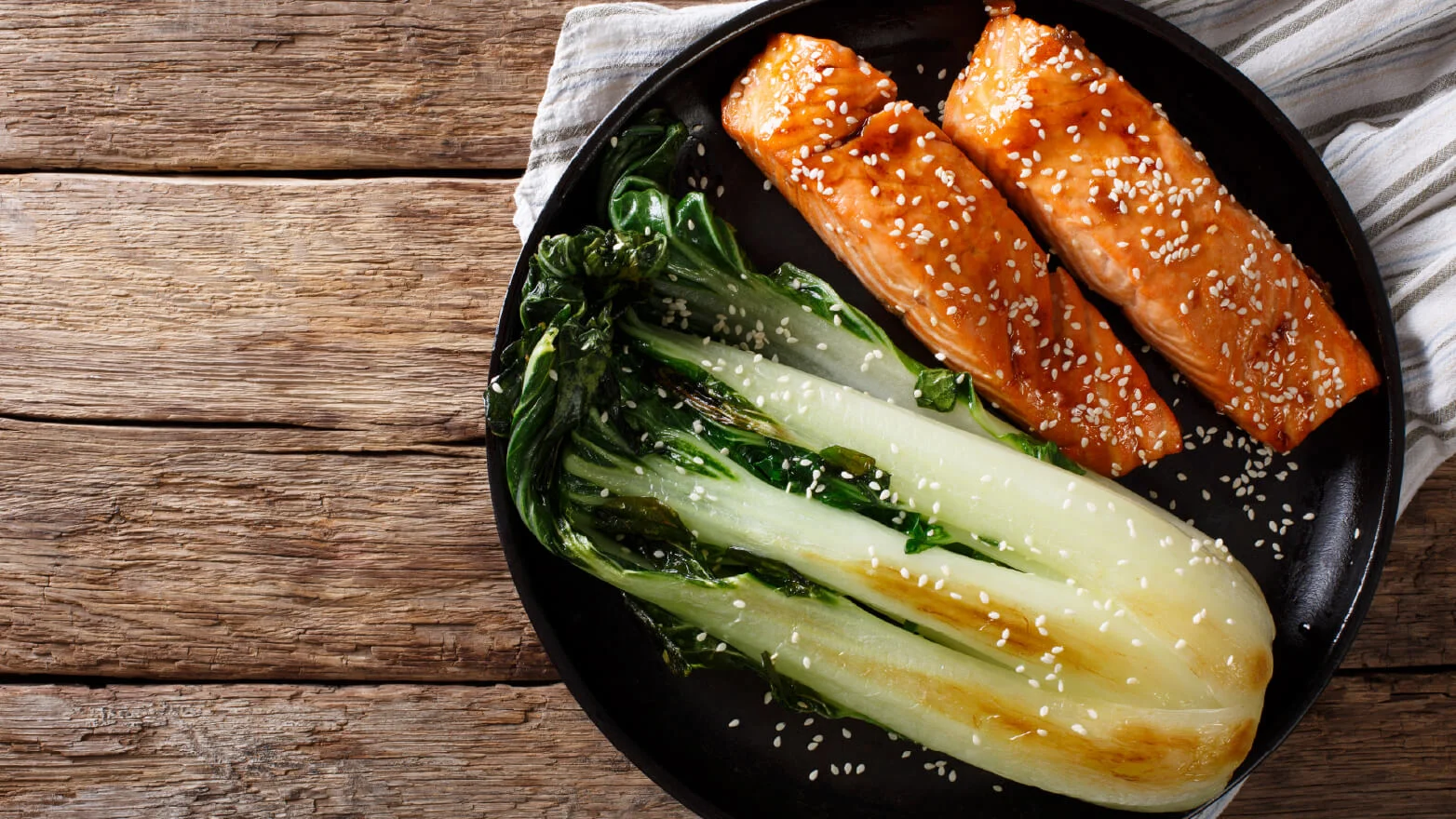 a photo of salmon in savory soy sauce with sesame seeds