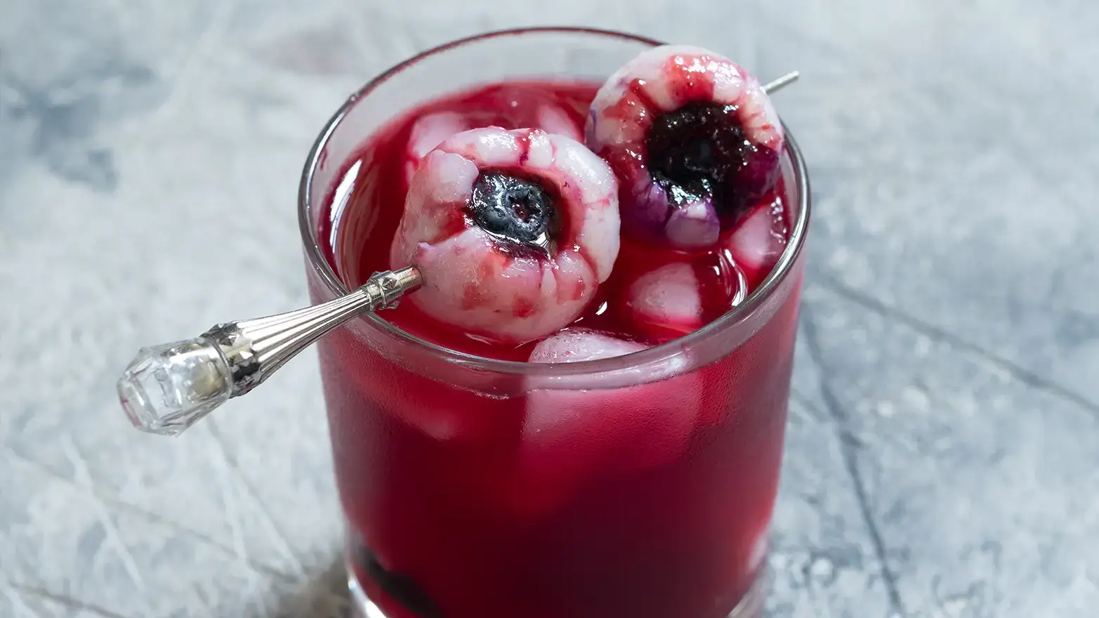 Lychee eyeballs served in a red cocktail