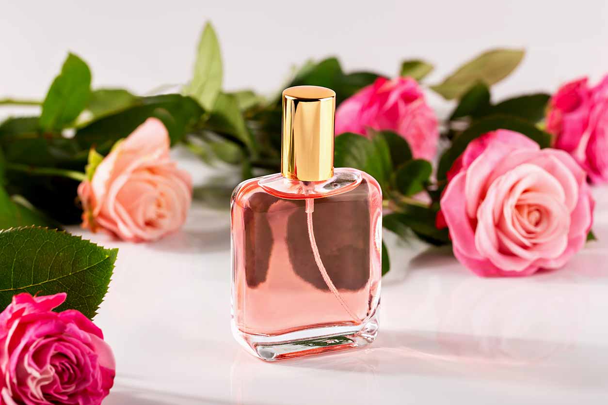 pink Valentine’s Day perfume surrounded by roses