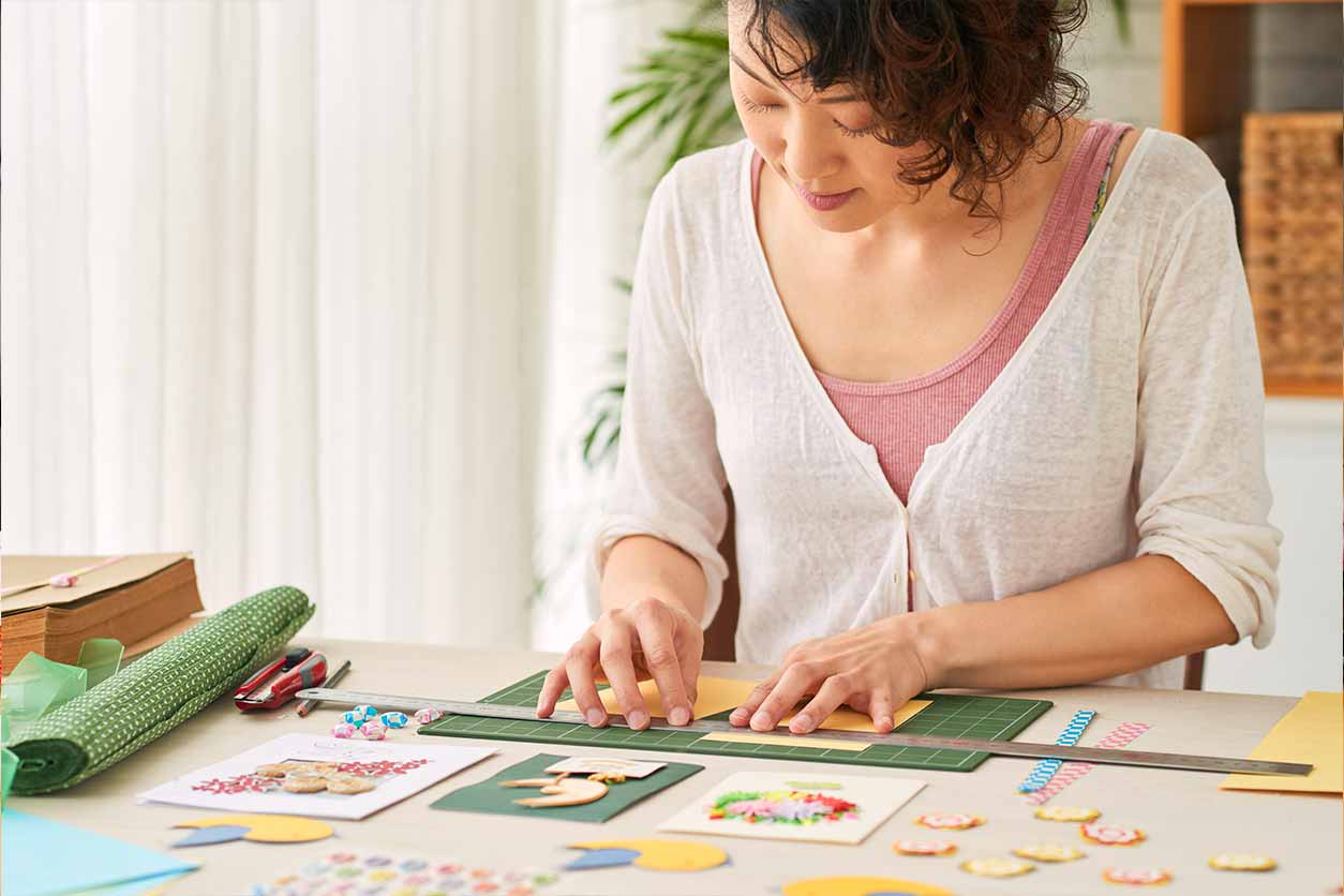 A woman working on a Valentine’s Day scrapbook