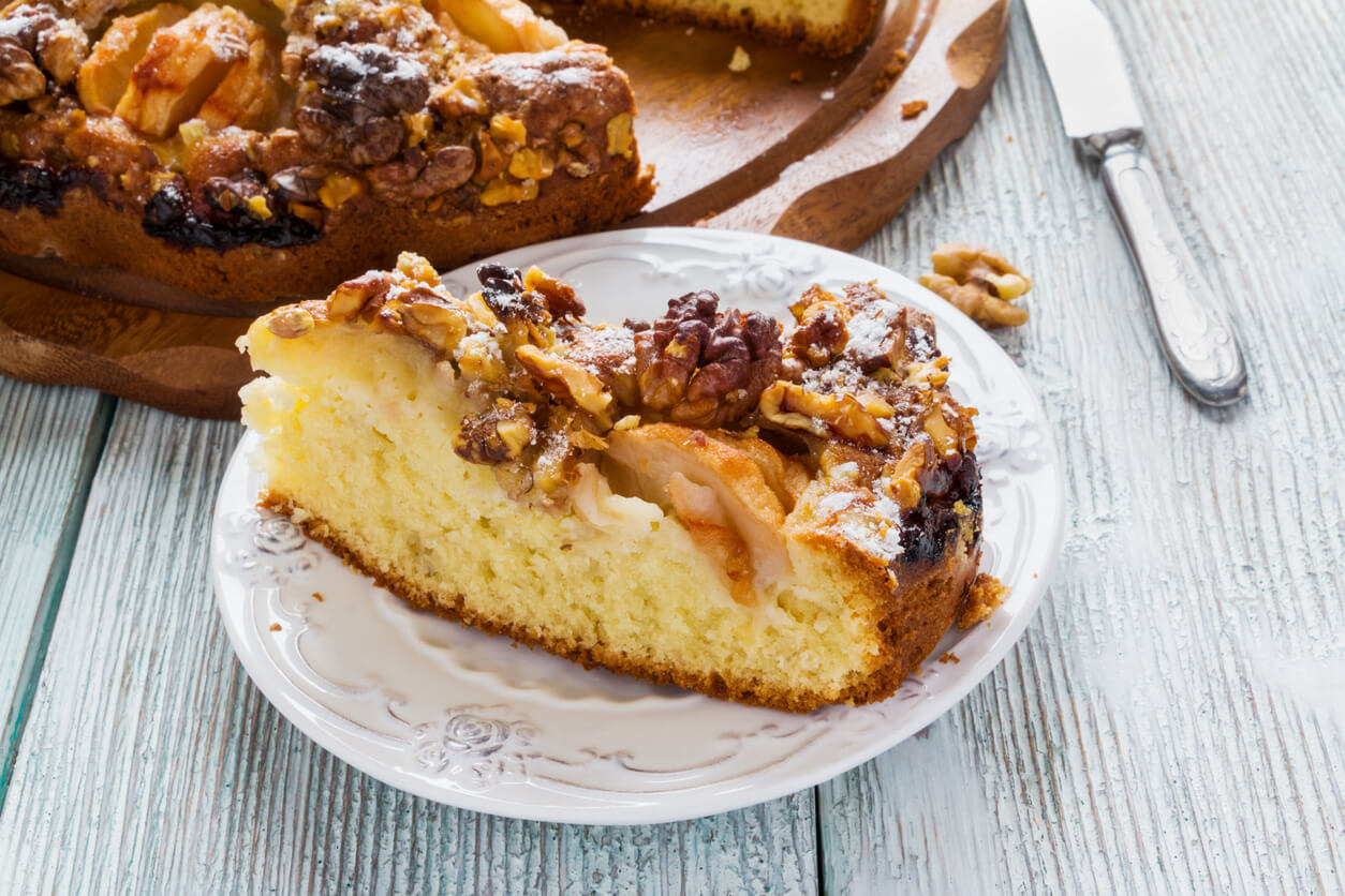 Homemade apple and walnuts cake on wooden board
