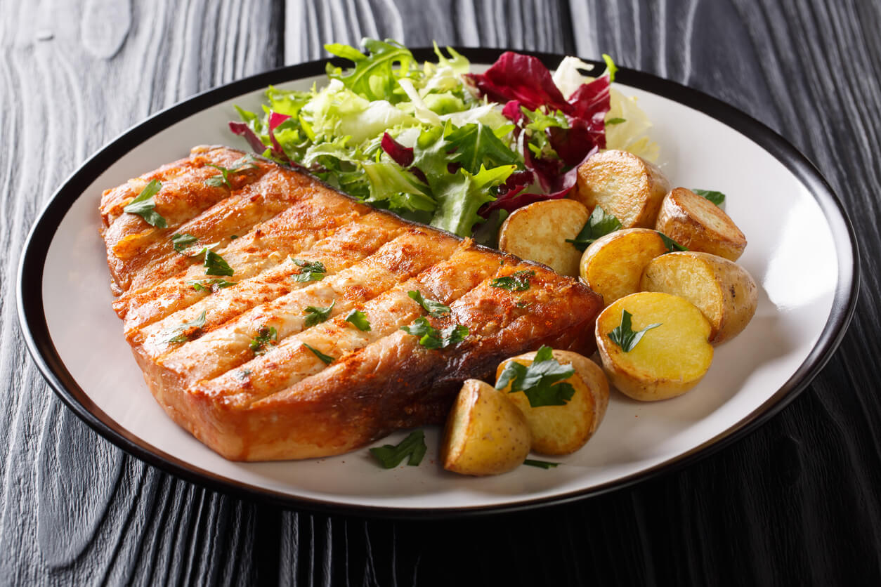 Grill steak swordfish served baby potato and fresh salad.
