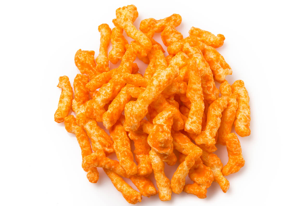 Heap of Cheese Puffs on white background
