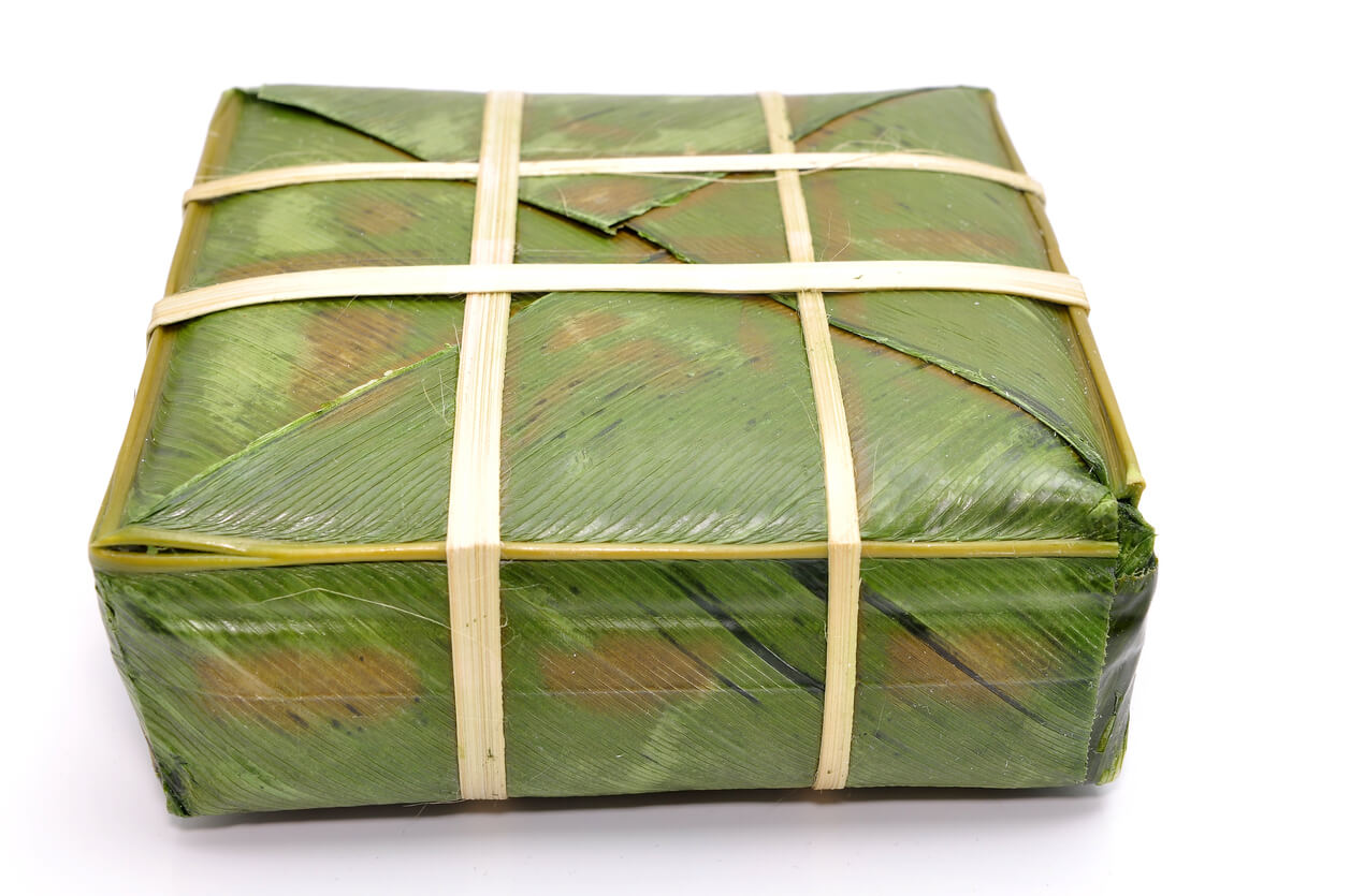 stuffed sticky rice cake or Banh Chung on a white background.