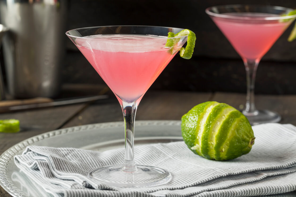 Homemade Pink Vodka Cosmopolitan Drink with a Lime Garnish