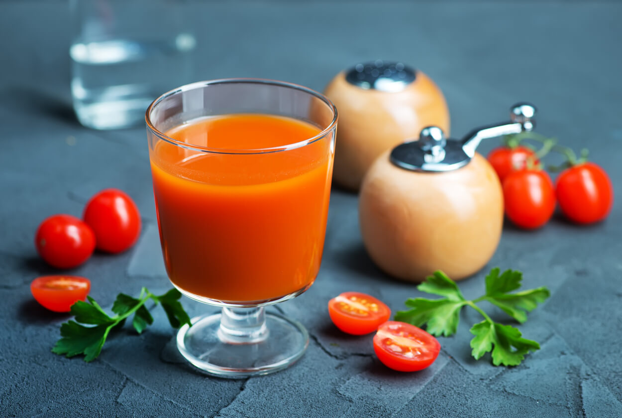 tomato juice in glass and vodka on a table