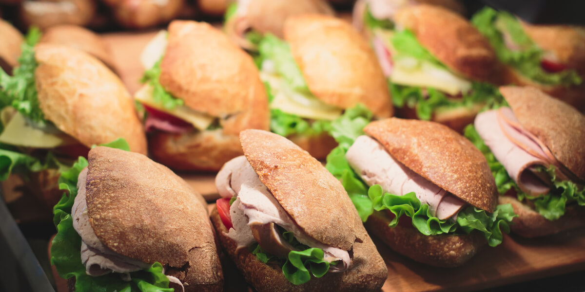 Beautifully multicolored decorated catering banquet table with sandwiches.