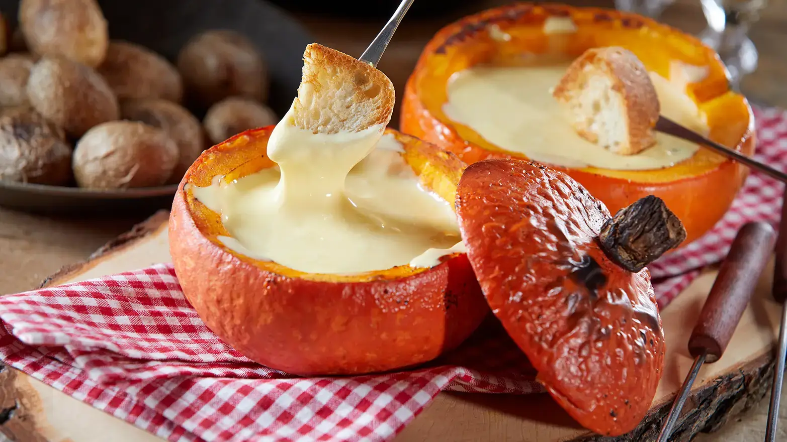 Cheese fondue served in pumpkin for Halloween potluck appetizer