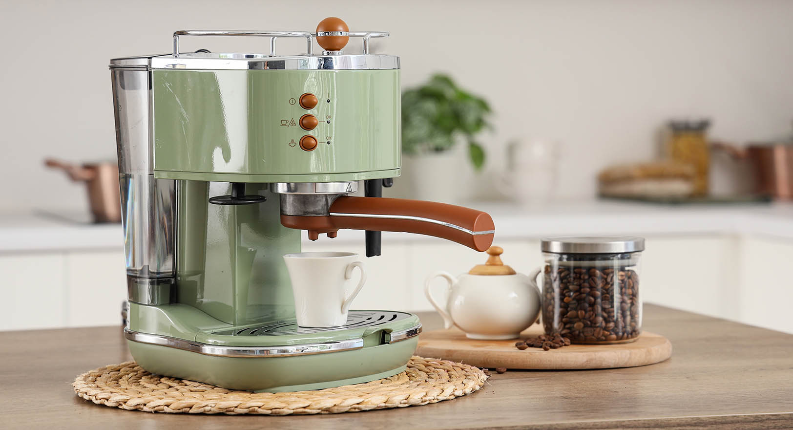 A photo of a green espresso machine on a wooden kitchen counter.