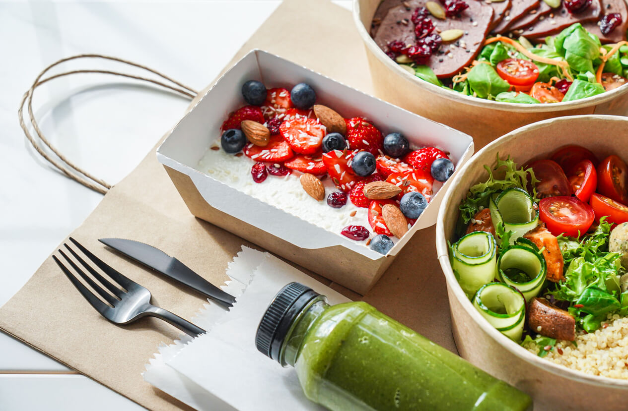 Healthy meal plan daily ready menu with berries, fork and knife, and veggie bowl.