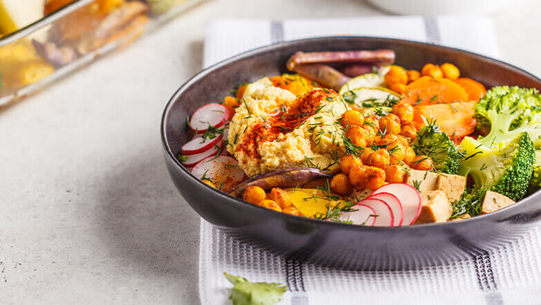 Top a buddha bowl with hummus for a healthy dose of protein.