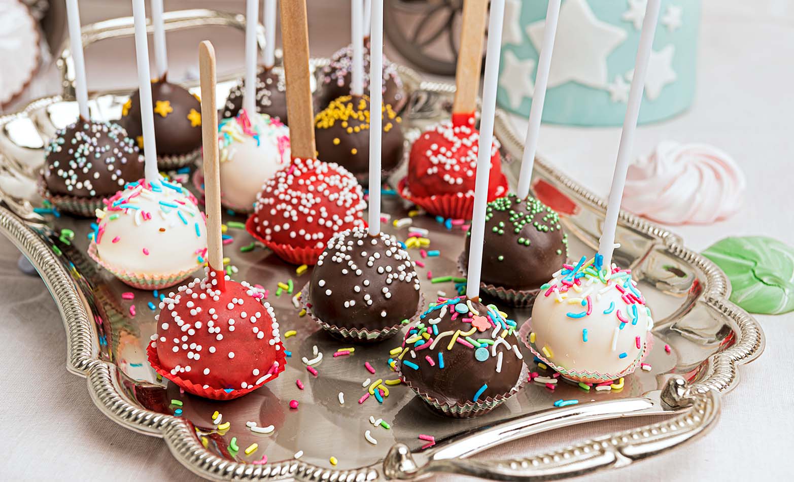 a serving platter of colorful cake pops with sprinkles