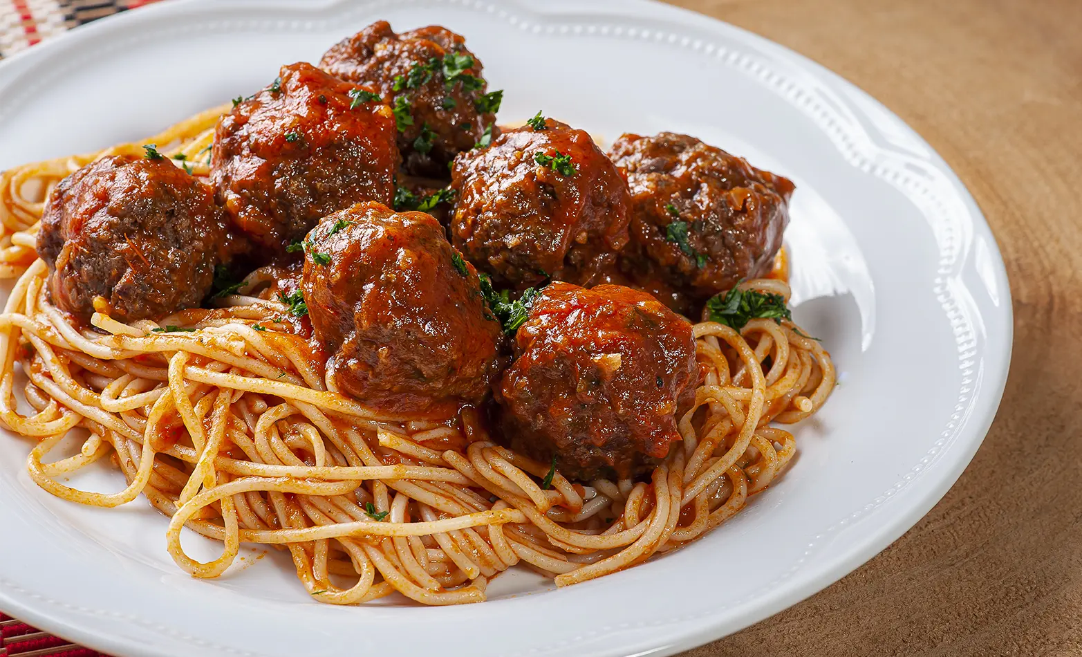 Homemade spaghetti and meatballs on a white plate