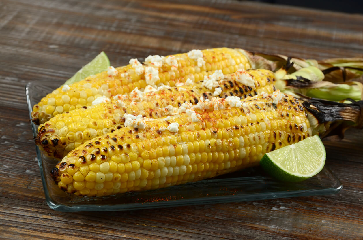 Elote or Mexican grilled corn on the cob served with cotija cheese and chili powder.