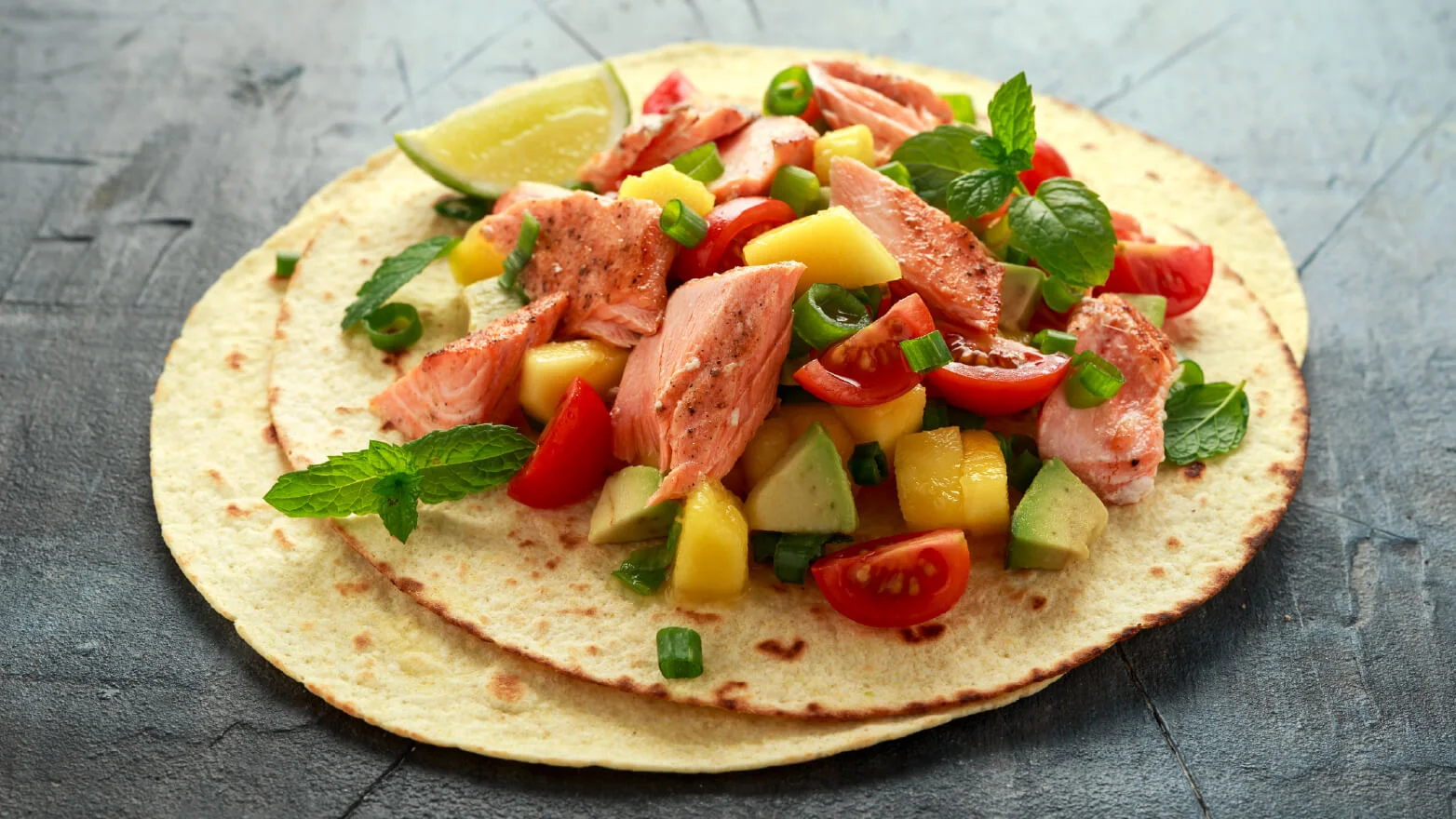 a photo of a grilled salmon taco with mango salsa