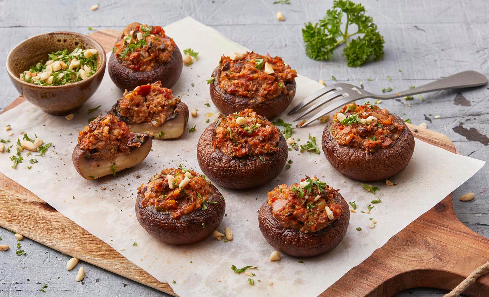 stuffed mushrooms on a wooden serving board