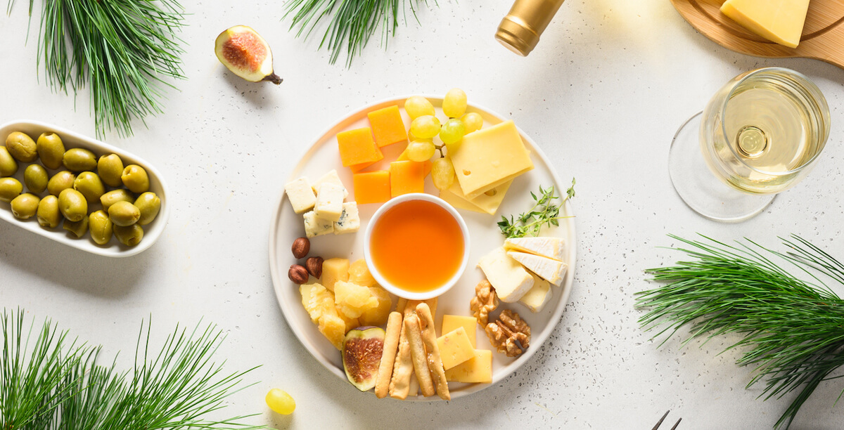 Christmas party with cheese platter, grapes, nuts, olive, figs. Appetizer for party.