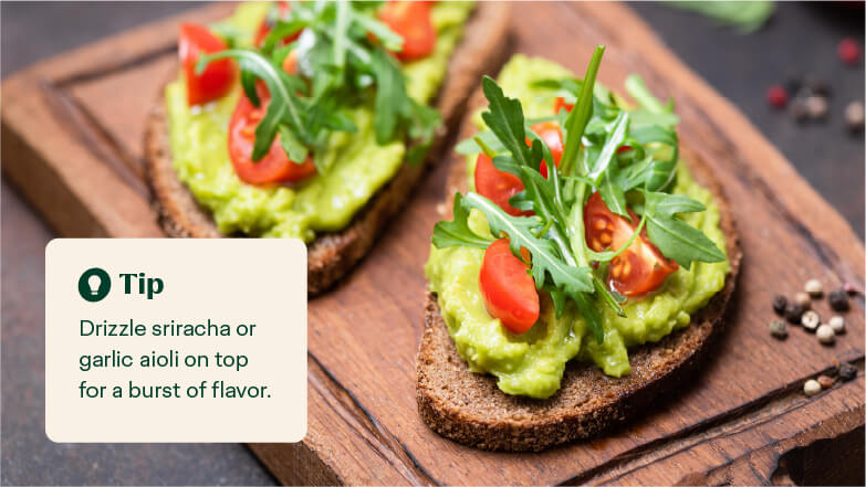 arugula avocado toast on serving plate