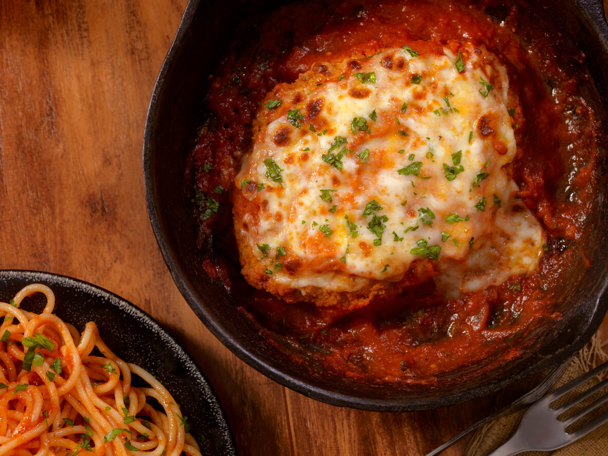 Chicken Parmesan Baked in Tomato Sauce with Spaghetti Mozzarella Cheese.