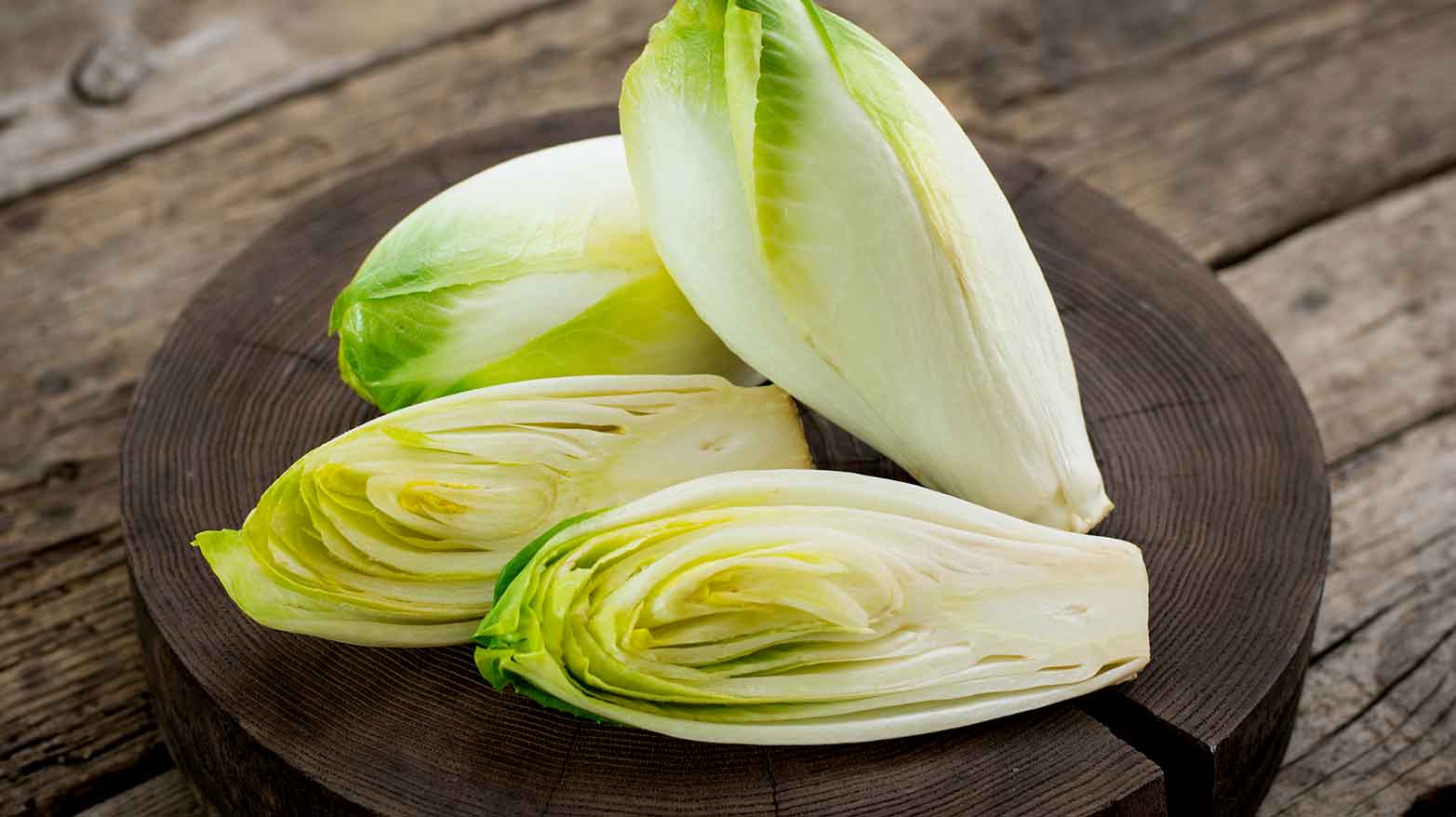 Cut endives on a wooden platter