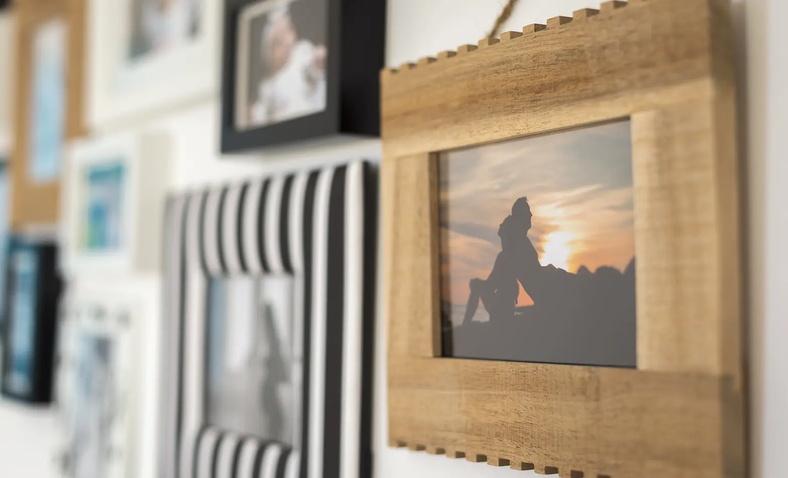 A photo of a gallery wall with personal photos.