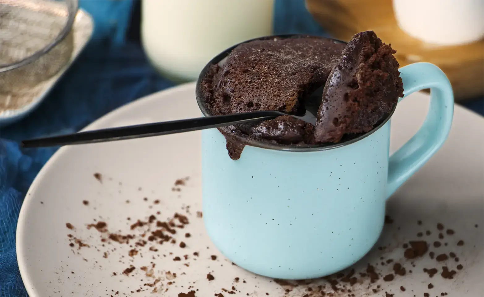 Chocolate keto mug cake in a light blue mug