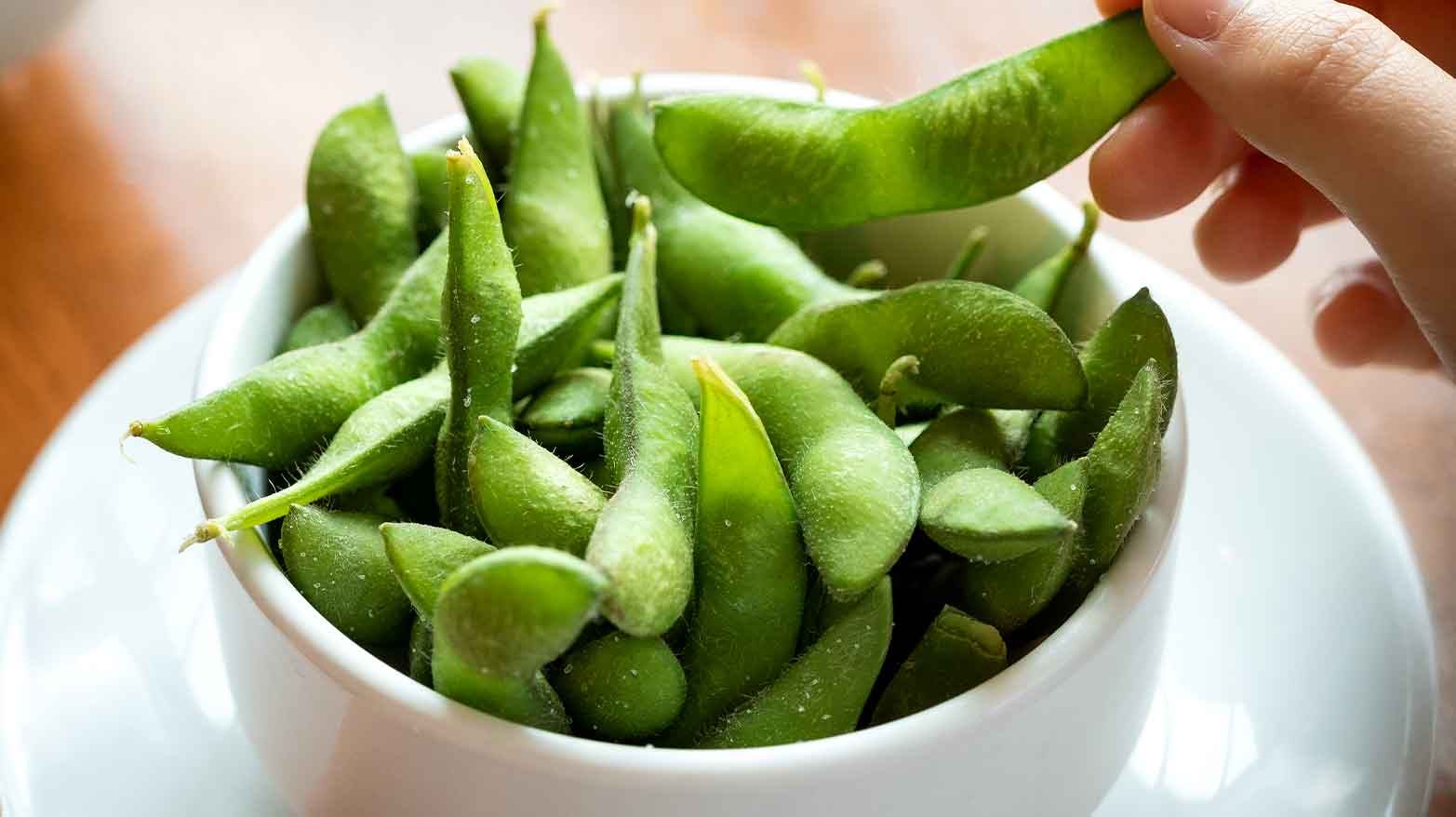 Cooked edamame in a white dish