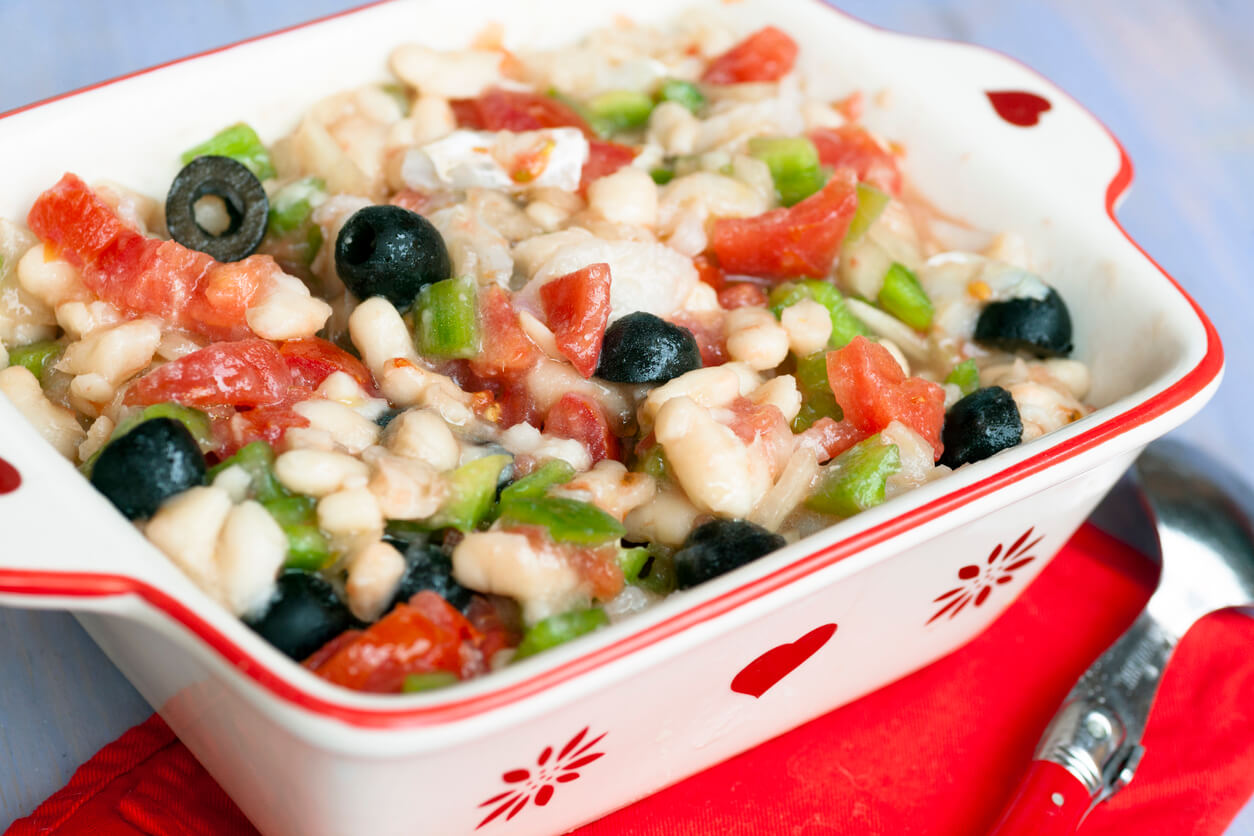 Beans and cod salad in a oven-safe platter.