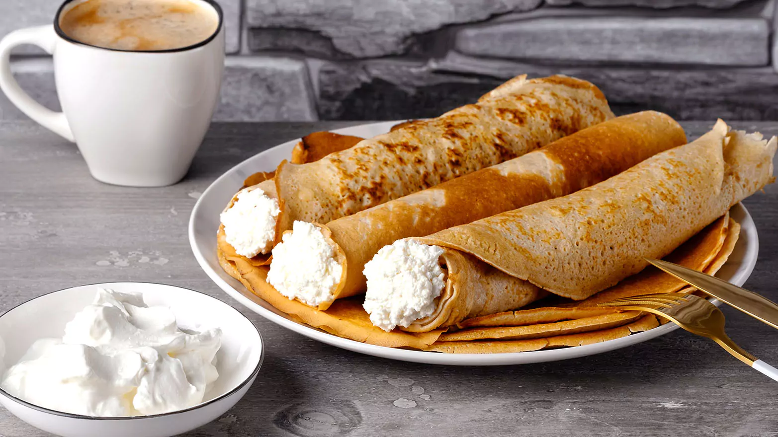 Apple cinnamon pancake roll-ups with a cup of coffee